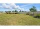 Large, grassy backyard featuring a neutral colored fence and lush landscaping at 13163 Mcmillan Dr, Orlando, FL 32827