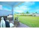 Covered patio with views of the manicured lawn, barbecue and outdoor seating at 13163 Mcmillan Dr, Orlando, FL 32827