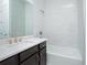 Well-lit bathroom with a soaking tub, dark cabinets and white stone countertop at 13163 Mcmillan Dr, Orlando, FL 32827