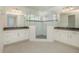 Primary bathroom with dual vanities, tile floors, and a walk-in glass shower at 13163 Mcmillan Dr, Orlando, FL 32827
