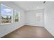 Light filled bedroom featuring wood floor and two windows at 13163 Mcmillan Dr, Orlando, FL 32827