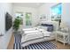 Bright bedroom features a large window, stylish decor, and neutral colors at 13163 Mcmillan Dr, Orlando, FL 32827