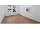 Cozy bedroom with wood-look flooring and abundant natural light from multiple windows at 13163 Mcmillan Dr, Orlando, FL 32827