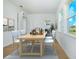 Sunlit dining room with wood floors, stylish furnishings, and backyard views at 13163 Mcmillan Dr, Orlando, FL 32827