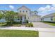 Charming two story home featuring a three-car garage, covered porch and landscaped yard at 13163 Mcmillan Dr, Orlando, FL 32827