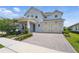 Charming two story home featuring a three-car garage and brick paved driveway at 13163 Mcmillan Dr, Orlando, FL 32827
