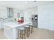 Bright kitchen features white cabinetry, stainless steel appliances, a large center island, and bar stool seating at 13163 Mcmillan Dr, Orlando, FL 32827