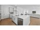Modern kitchen featuring stainless steel appliances, quartz countertops, and wood flooring at 13163 Mcmillan Dr, Orlando, FL 32827