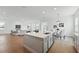 Open-concept kitchen with stainless steel appliances, large center island and hardwood flooring throughout at 13163 Mcmillan Dr, Orlando, FL 32827