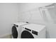Laundry room featuring a side-by-side washer and dryer with wire shelving at 13163 Mcmillan Dr, Orlando, FL 32827
