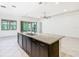 Large kitchen island with a stainless steel dishwasher and a view of the outdoor space at 8325 Topsail Pl, Winter Garden, FL 34787