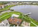 Aerial view of a playground with a lake backdrop, including a picnic shelter and sandy volleyball court at 8325 Topsail Pl, Winter Garden, FL 34787