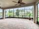 Expansive screened patio with brick flooring, ceiling fans, and views of lush greenery at 8325 Topsail Pl, Winter Garden, FL 34787