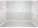 Walk-in closet with white wire shelving and tile flooring for clothing and storage at 8325 Topsail Pl, Winter Garden, FL 34787