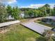 Aerial view of property showcasing pool, lake access and lush landscaping at 226 Mitnik Dr, Deltona, FL 32738