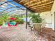 Relaxing pool area with covered patio, seating, and lush landscaping at 226 Mitnik Dr, Deltona, FL 32738