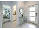 Inviting foyer featuring a modern glass table, and views to the bedroom and bathroom at 2709 Scrapbook St, Kissimmee, FL 34746