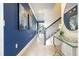 Hallway with staircase, stylish runner, large wall art, and view of living area at 2709 Scrapbook St, Kissimmee, FL 34746