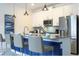Modern kitchen with white cabinets, stainless steel appliances, and seating at the island at 2709 Scrapbook St, Kissimmee, FL 34746