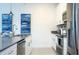 Bright kitchen with stainless steel appliances, white cabinetry, and ample counter space at 2709 Scrapbook St, Kissimmee, FL 34746