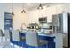 Modern kitchen with white cabinets, stainless steel appliances, and seating at the island at 2709 Scrapbook St, Kissimmee, FL 34746