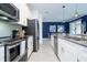 Spacious kitchen featuring white cabinets, stainless steel appliances, and modern finishes at 2709 Scrapbook St, Kissimmee, FL 34746