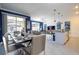 Open-concept dining and living space with modern furnishings, a kitchen island, and access to pool at 2709 Scrapbook St, Kissimmee, FL 34746