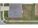Aerial view of a residential building featuring a gray shingled roof and a tidy yard at 1103 Epson Oaks Way, Orlando, FL 32837
