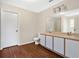 Bright bathroom featuring a double sink vanity, toilet, and neutral wall color at 1103 Epson Oaks Way, Orlando, FL 32837