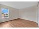 An empty bedroom with laminate floors and a view from a window at 1103 Epson Oaks Way, Orlando, FL 32837