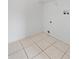Tiled laundry room with connections, showing a practical space with a shelf for organization at 1103 Epson Oaks Way, Orlando, FL 32837