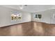 Spacious living room with wood-look flooring, a ceiling fan, and abundant natural light at 1103 Epson Oaks Way, Orlando, FL 32837