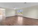 An open living space with sleek floors, a ceiling fan, and bright natural light at 1103 Epson Oaks Way, Orlando, FL 32837
