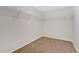 Walk in closet featuring wire rack shelving and neutral carpet at 1103 Epson Oaks Way, Orlando, FL 32837