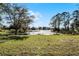 Scenic property overlooking a tranquil lake, with lush green grass at 2142 Hainlin Ct, Deltona, FL 32738