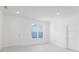A bright, well-lit bedroom featuring clean white walls and light gray tile flooring at 442 Marion Oaks Crse, Ocala, FL 34473