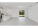 Bright, open-concept living space with gray tile flooring and sliding glass doors at 442 Marion Oaks Crse, Ocala, FL 34473