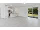 Bright, open-concept living space with gray tile flooring and sliding glass doors at 442 Marion Oaks Crse, Ocala, FL 34473
