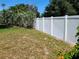 White privacy fence in a green backyard with pretty plantings offering seclusion at 10161 Culpepper Ct, Orlando, FL 32836