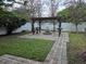 Backyard with a fire pit, seating and a pergola, perfect for outdoor entertaining at 10161 Culpepper Ct, Orlando, FL 32836