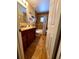 Well-lit bathroom featuring a wood vanity with dark cabinets and a tiled shower/tub combo at 10161 Culpepper Ct, Orlando, FL 32836