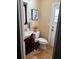 Cozy half bath featuring a modern vanity, toilet, stylish decor, and convenient access to an exterior door at 10161 Culpepper Ct, Orlando, FL 32836