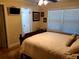 Cozy bedroom featuring a large bed and a view into the en-suite bathroom at 10161 Culpepper Ct, Orlando, FL 32836