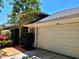 Home featuring a large garage, arched entry and attractive landscaping at the entrance, enhancing its curb appeal at 10161 Culpepper Ct, Orlando, FL 32836