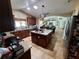Open kitchen with granite counters, tiled floors, a center island, stainless steel appliances and easy access to dining area at 10161 Culpepper Ct, Orlando, FL 32836