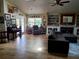 Cozy living room featuring tile floors, comfortable seating, and a fireplace with built-in shelving for a relaxing ambiance at 10161 Culpepper Ct, Orlando, FL 32836