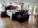 Bright and airy main bedroom with tiled floor, comfortable sitting area, decorative furnishings, and access to the backyard at 10161 Culpepper Ct, Orlando, FL 32836