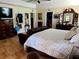 Comfortable main bedroom features tiled floors, tray ceiling, dark wood furniture, and an ensuite bathroom and walk-in closet at 10161 Culpepper Ct, Orlando, FL 32836
