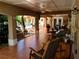 Spacious covered tile patio with ceiling fans, offering multiple seating areas and garden views at 10161 Culpepper Ct, Orlando, FL 32836
