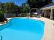 Sparkling pool with ample deck space and a pergola, ideal for outdoor relaxation at 10161 Culpepper Ct, Orlando, FL 32836